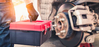 mechanic holding a toolbox